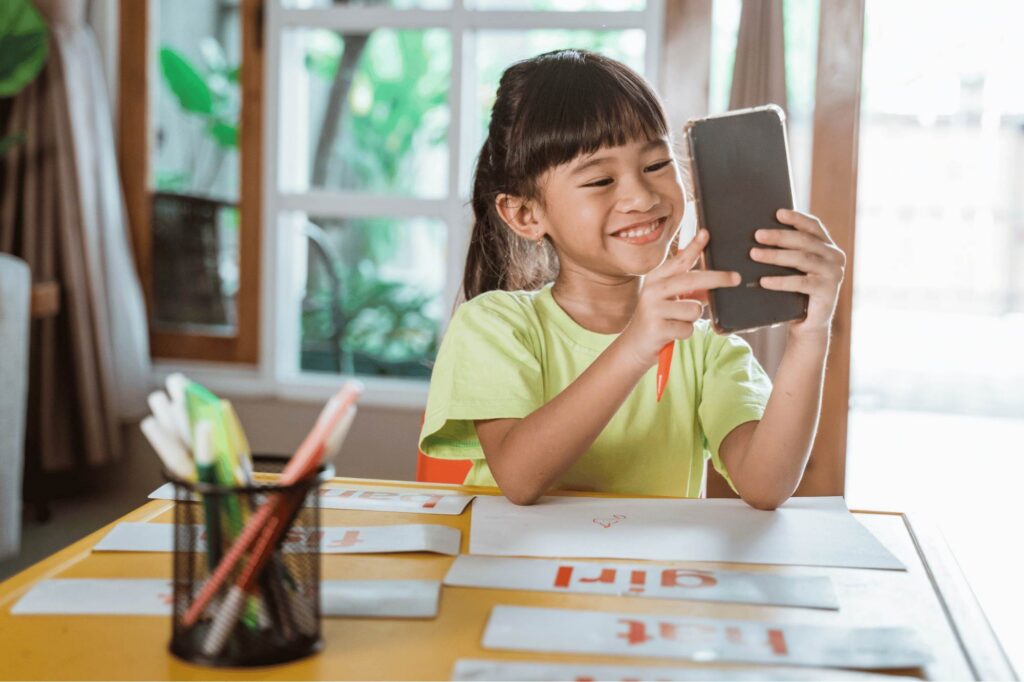 Girl with nomophobia distracted by her phone forgetting her schoolwork